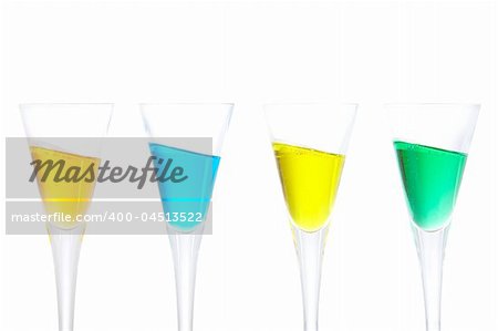 Four glasses of beverages on angle, white background. Shallow depth of field