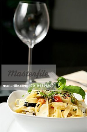 nice prepared tagliatelle on the table with fork and wine