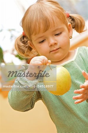 Cute girl playing whit green apple