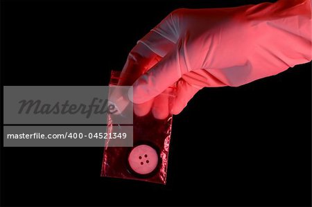 Hand in glove holding the evidence, isolated on black background