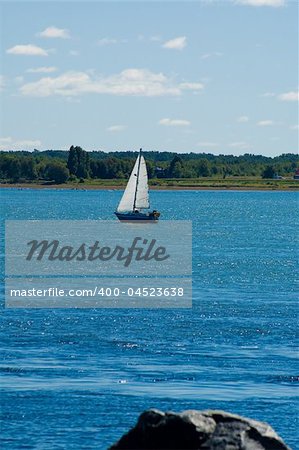 A little sail boat sailing on the river