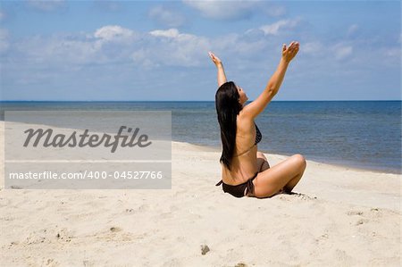 attractive brunette woman relaxing on beach