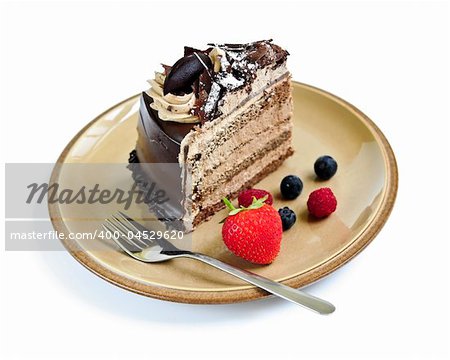 Slice of chocolate mousse cake served on a plate on white background