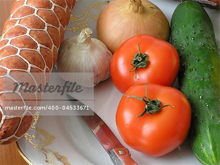 On a photo still life. On a photo  vegetable and sausage. It is made in Ukraine