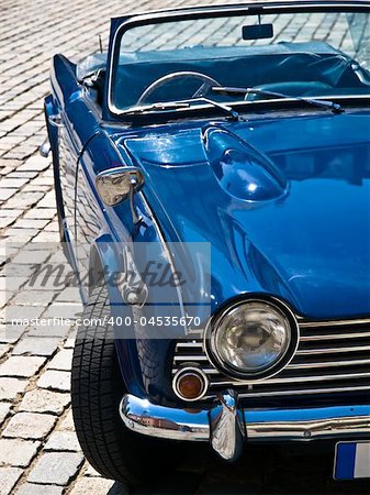 Blue Oldtimer in perfect condition posing on a street