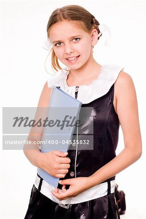 Smiling pretty schoolgirl in dress holding a file