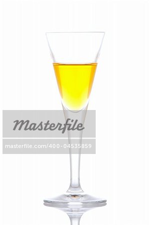 Glass of yellow paradise cocktail reflected on white background