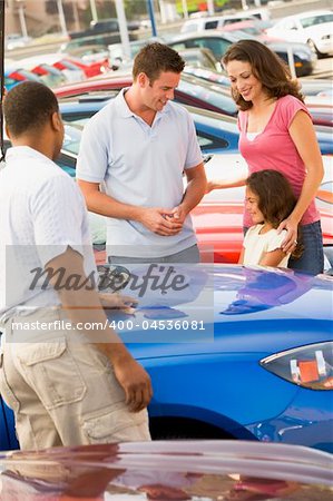 Family choosing new car on lot