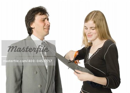 Pretty woman cutting man's necktie with scissors