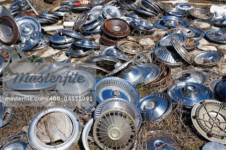 Old metal hubcaps strewn across the ground.