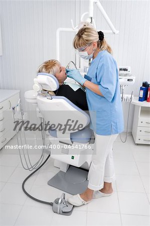 doctor works with patient in the dentist office