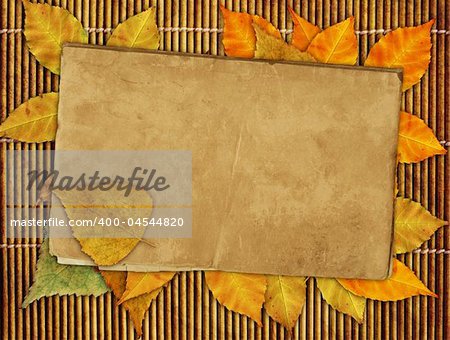 Japanese reed mat, paper sheet and autumn leafs
