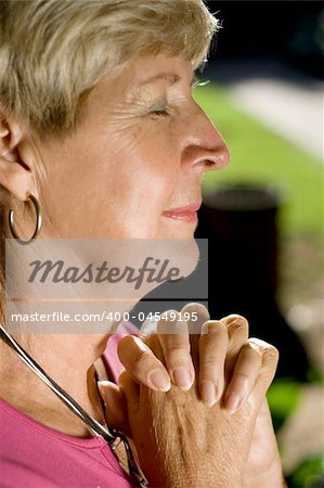 elegant senior woman praying