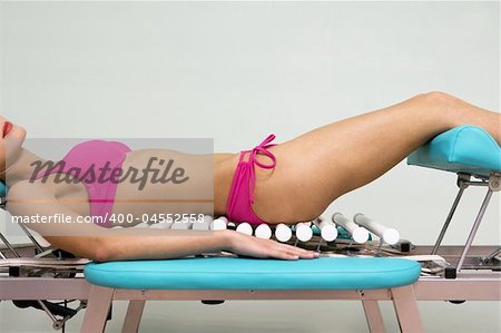 The girl in a pink bikini on a massage table