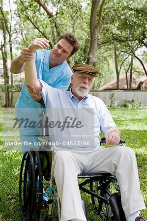 Physical therapist working with disabled senior man outdoors in a natural setting.