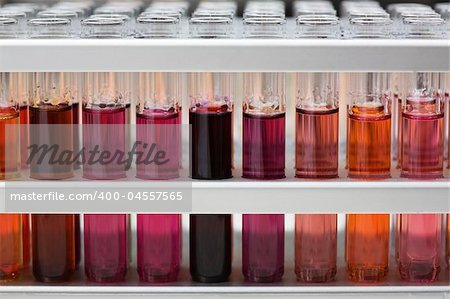 It is a lot of test tubes with color liquids. Close-up, shallow depth of field.