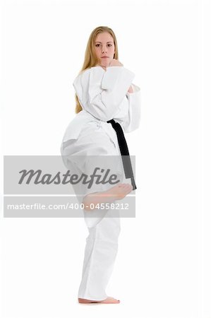 Black belt female martial artist doing low side kick