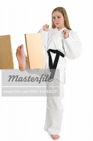 Black belt female martial artist doing board break.