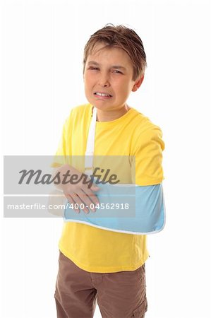 Injured young boy with sore arm in an arm sling