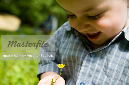 Happy Baby Boy With Flower