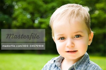 Little Smiling Baby On Natural Background