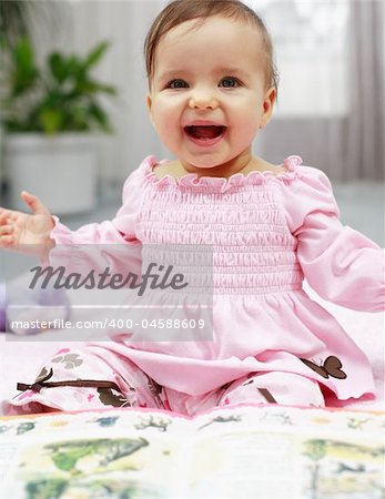 Portrait of cute baby reading a picture book and have a fun