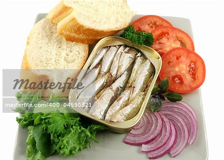 Sardines with bread, red onion, tomato, lettuce. and red basil.