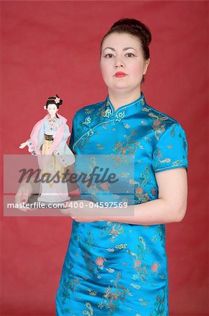Japanese girl with doll on the red background