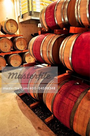 Stacked oak wine barrels in winery cellar