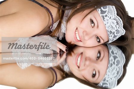 Portrait of the smiling young woman laying on a mirror