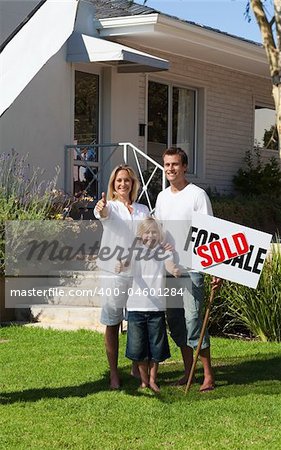 Young Happy Family holding Sold Sign