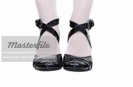 Black feminine loafers with band on feminine leg in white pantyhose