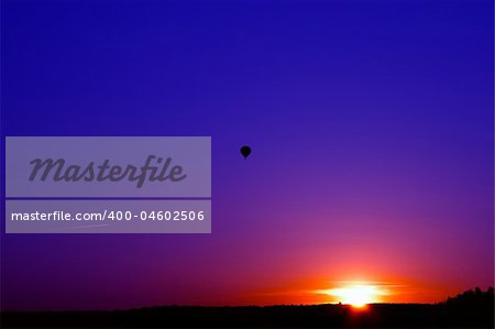 Sunset over the forest. Flying a balloon and aircraft.