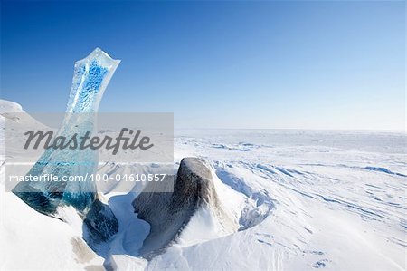 A piece of glacial ice sticking out of the frozen ocean, Spitsbergen, Svalbard, Norway