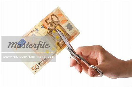 The female hand cuts the banknote with scissors