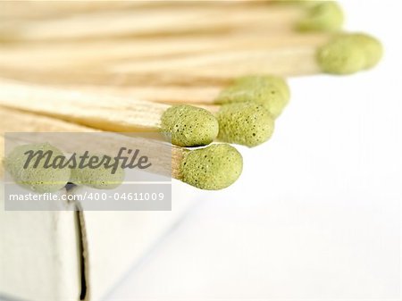 matches sticking out of the matchbox, macro shot over white background with copy space, shallow DOF