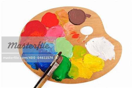 Two paintbrush on the palette with bright acrylic paints