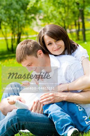 Mother, father and baby in the park