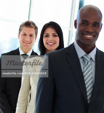 Smiling young  businesswoman in focus with her team in a row