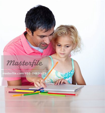 Father and daughter writing together at home