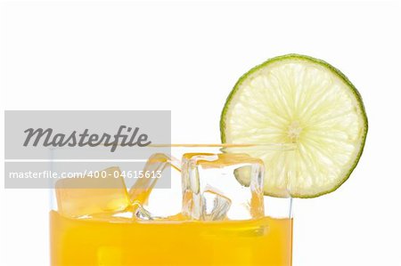 A glass of orange juice with a lime slice , isolated on white background