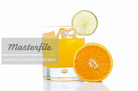 A glass of orange juice with a lime slice , isolated on white background
