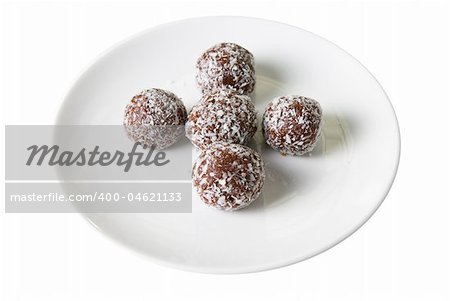 Chocolate ball cakes at plate  isolated on white background