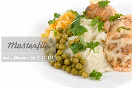 Healthy restaurant food: meatballs, potatoes, verdure, peas and corn on white. Close up.