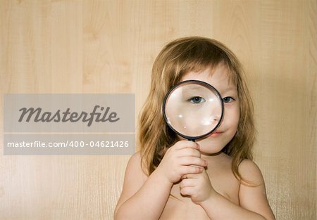 little girl with big magnifier look for something