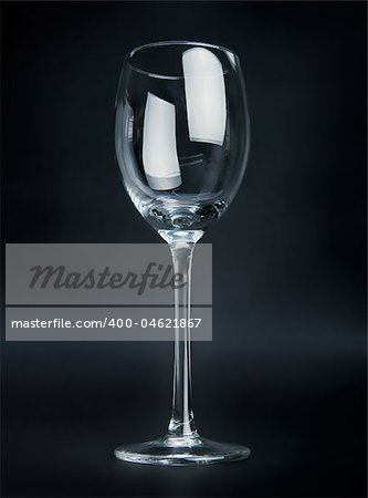 Empty wineglass on black background