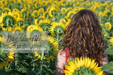 Beautiful woman in the field of sunflowers