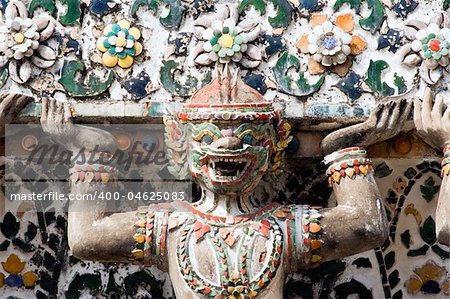 Close up of demon statue on the Buddhist temple Wat Arun in Bangkok, Thailand.