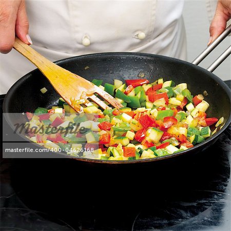 Chef frying peppers