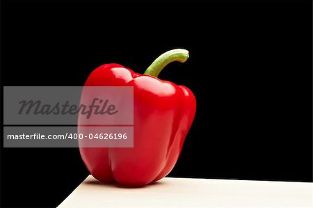 isolated red pepper on black background